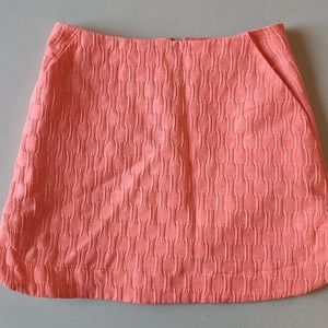 Top Shop coral athletic/golf skirt with pockets, lines and high/low sides size 2